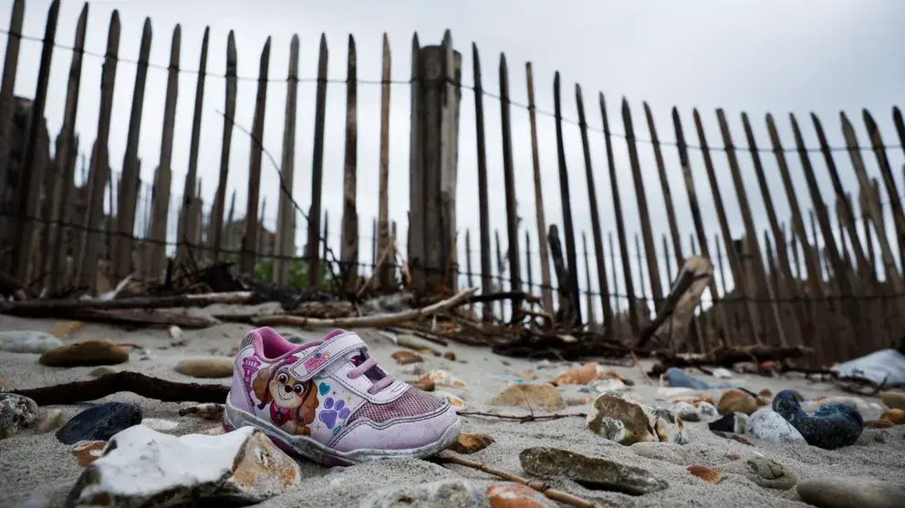 لنگه کفش باقی‌مانده از یک کودک مهاجر در سواحل منطقه ویمرو، فرانسه، ۱۴ سنبله